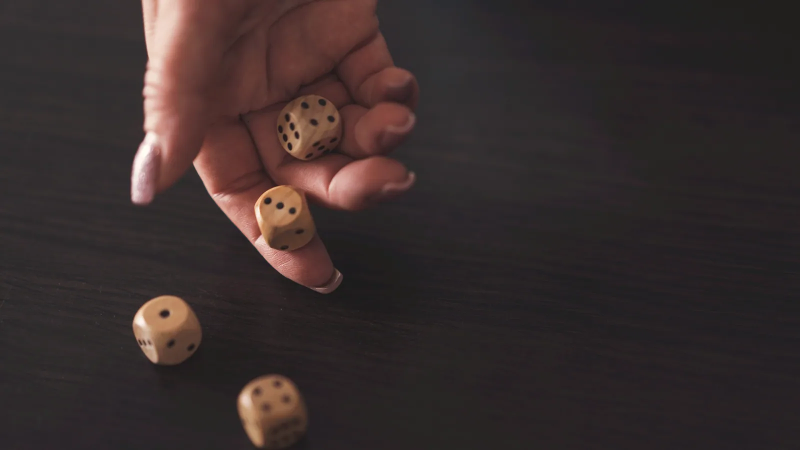 Photographie : des pions et des dés en bois posés sur une table